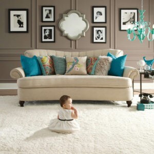 plus carpet in living room with child sitting on floor | Flooring Express | Lafayette, IN