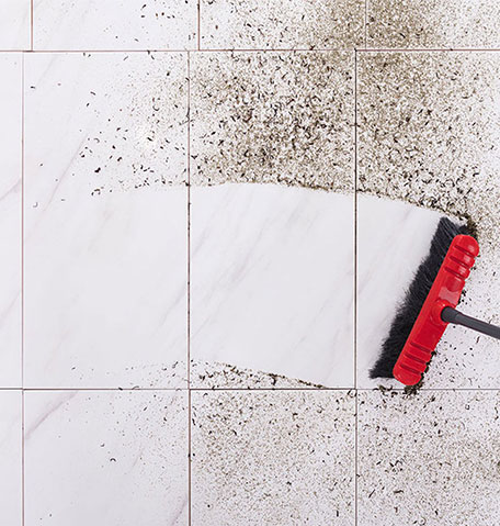 Broom sweeping dirt off a tile floor | Flooring Express | Lafayette, IN