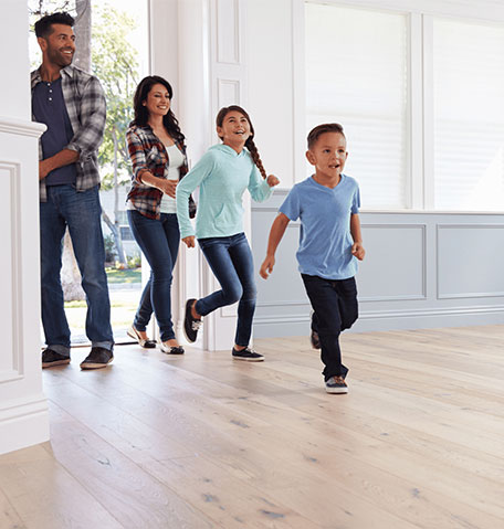 A family running on hardwood floors | Flooring Express | Lafayette, IN